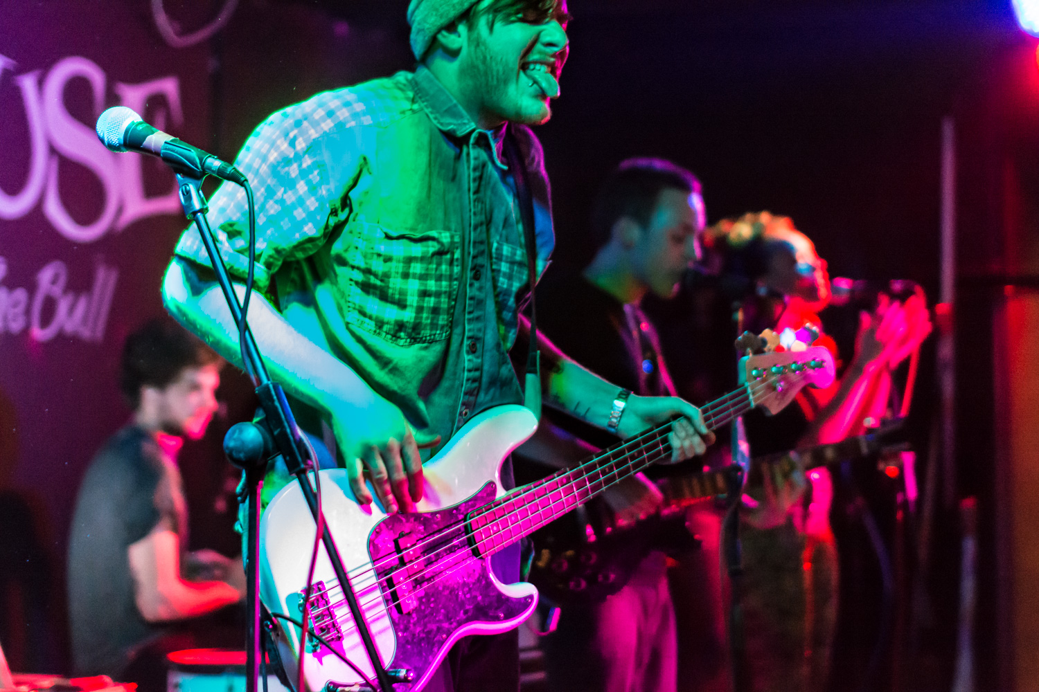 Band picture of bassist with tongue out