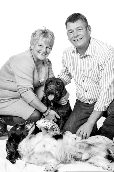 Pet photography portrait of couple with dogs